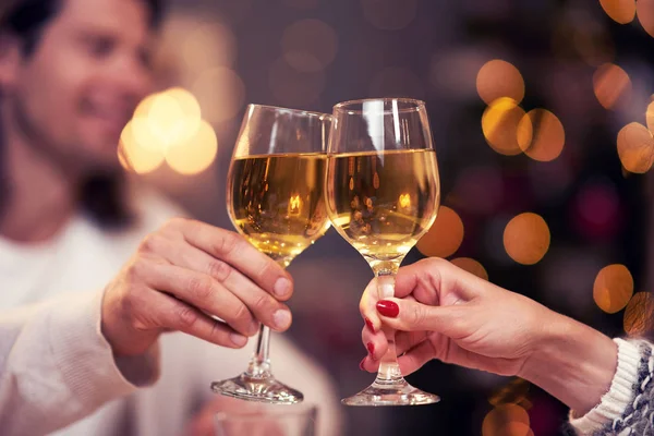 Adult couple toasting wine over Christmas background — Stock Photo, Image