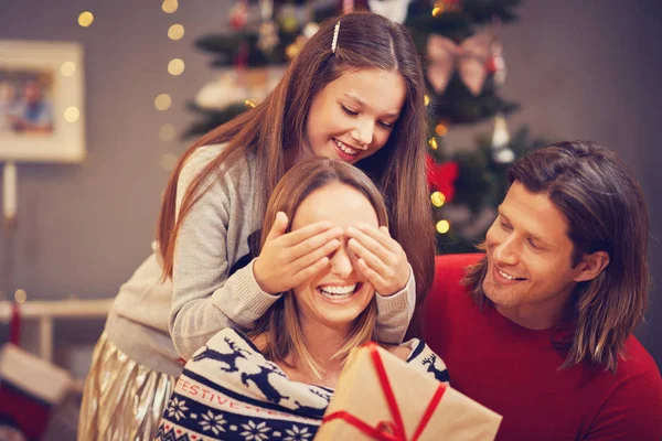 Beautiful family with presents over Christmas tree — Stock Photo, Image