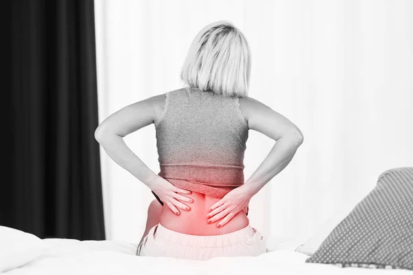 Adult woman feeling unewll suffering from backache pain — Stock Photo, Image