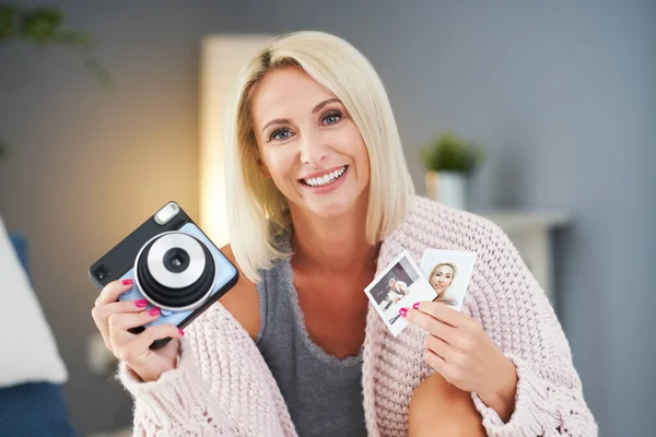 Adulto bela mulher tirar foto instantânea em casa — Fotografia de Stock