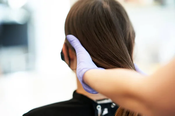 Vuxen kvinna på frisören bär skyddsmask på grund av coronavirus pandemi — Stockfoto