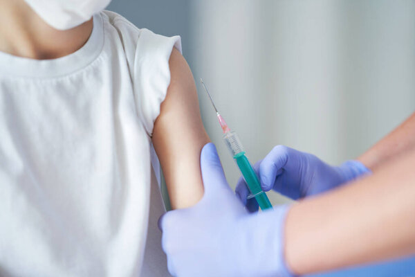 Portrait of adorable little boy being vaccinate at doctors office Stock Photo