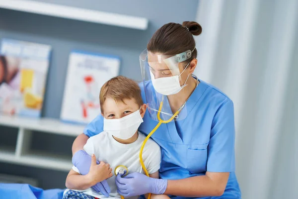 Portrait of adorable little boy being tested by doctor with stethoscope — Stock Photo, Image