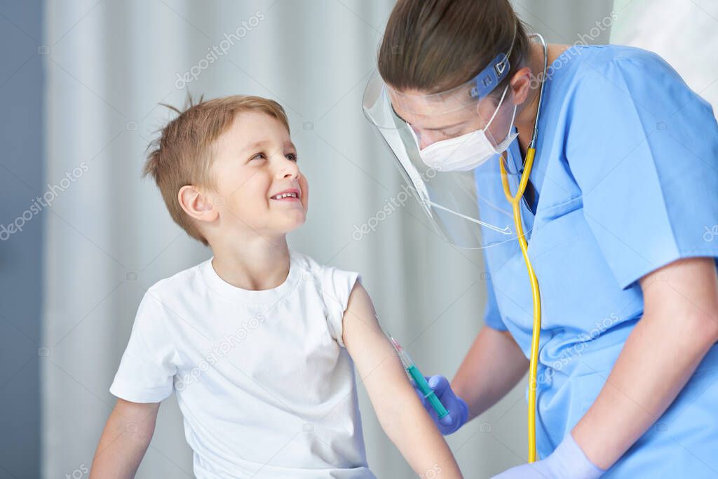 Portrait of adorable little boy being vaccinate at doctors office