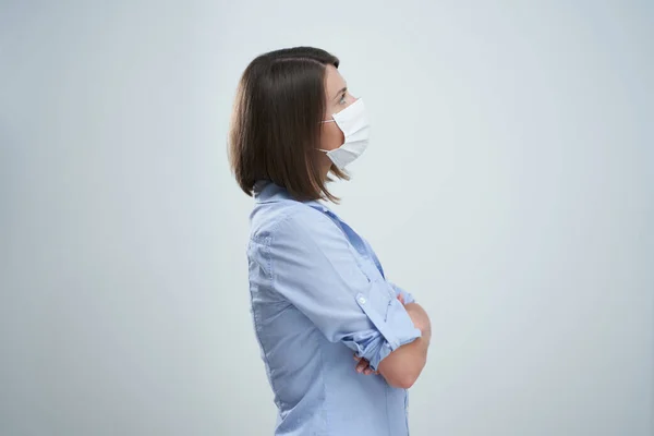 Mulher atraente usando máscara protetora isolada sobre fundo branco — Fotografia de Stock