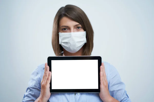 Woman wearing protective mask and holding tablet isolated over white background — Stock Photo, Image