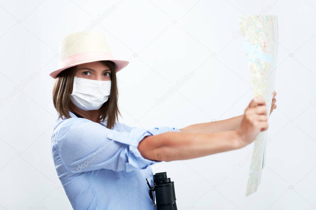 Woman tourist wearing protective mask isolated over white background