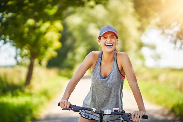 Young happy woman on a bike in countryside — Stock Photo, Image