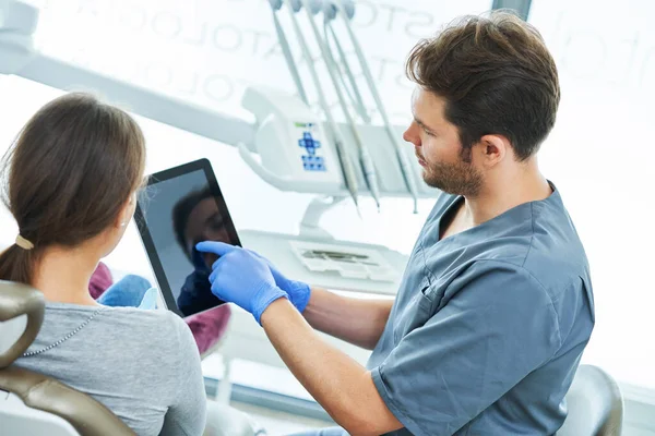 Homem dentista e mulher no consultório odontológico — Fotografia de Stock