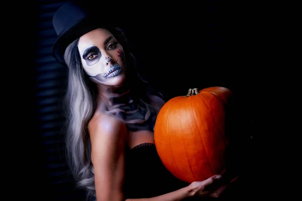 Spooky portret van vrouw in halloween gotische make-up houden pompoen — Stockfoto