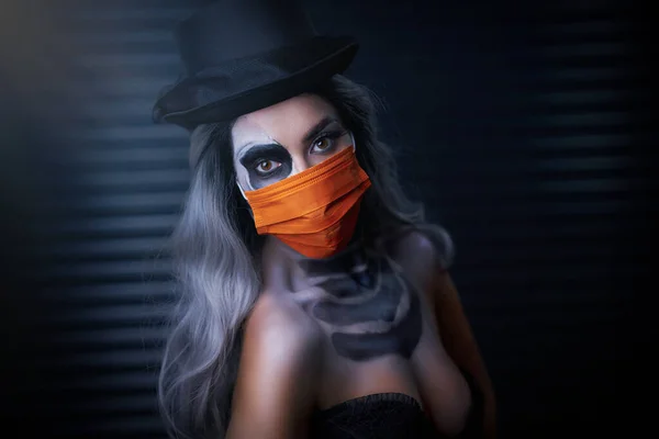 Spooky portrait of woman in halloween gotic makeup wearing protective mask — Stock Photo, Image