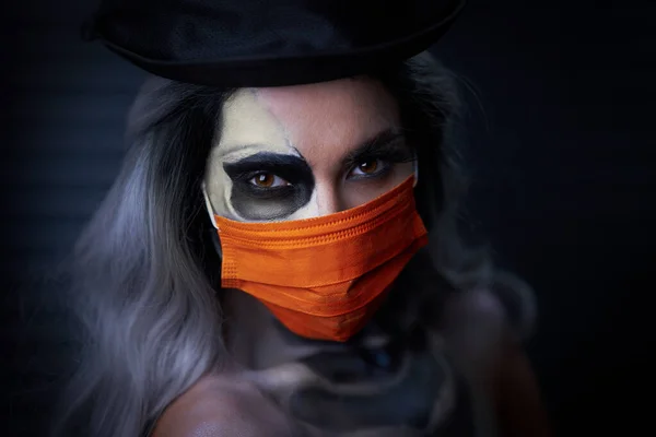 Spooky portrait of woman in halloween gotic makeup wearing protective mask — Stock Photo, Image