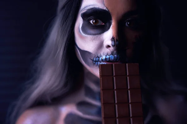 Spooky portrait of woman in halloween gotic makeup holding chocolate — Stock Photo, Image