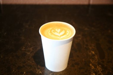 Masada kalbi olan bir fincan kahve.