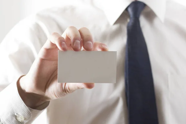 Hand holding white business card on white background — Stock Photo, Image