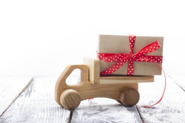 Toy car with Christmas gifts and tree isolated on white backround. Delivery.