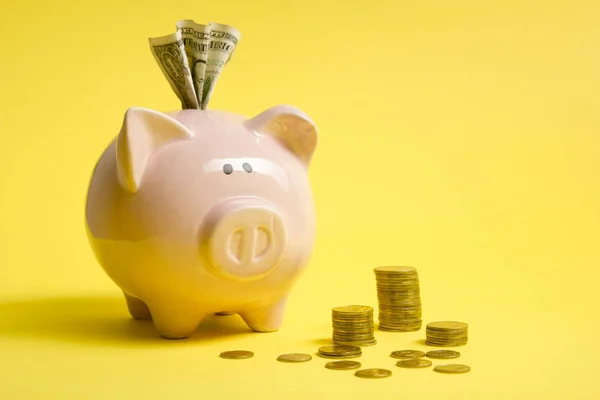 Piggy bank isolated on yellow background. Savings concept