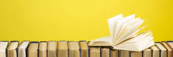 Open book, hardback books on wooden table. Back to school. Copy space