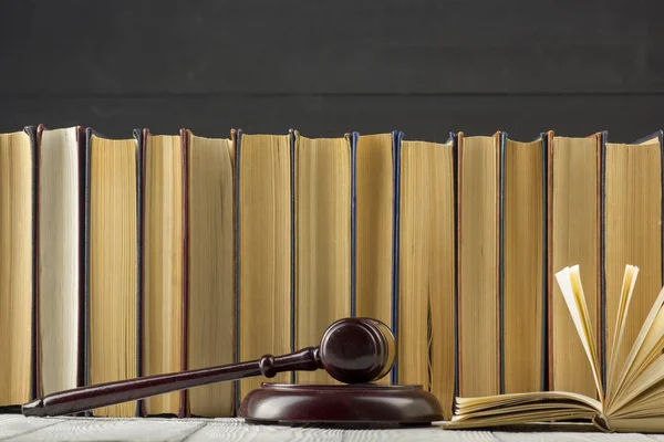 Legal Law concept - Open law book with a wooden judges gavel on table in a courtroom or law enforcement office. — Stock Photo, Image