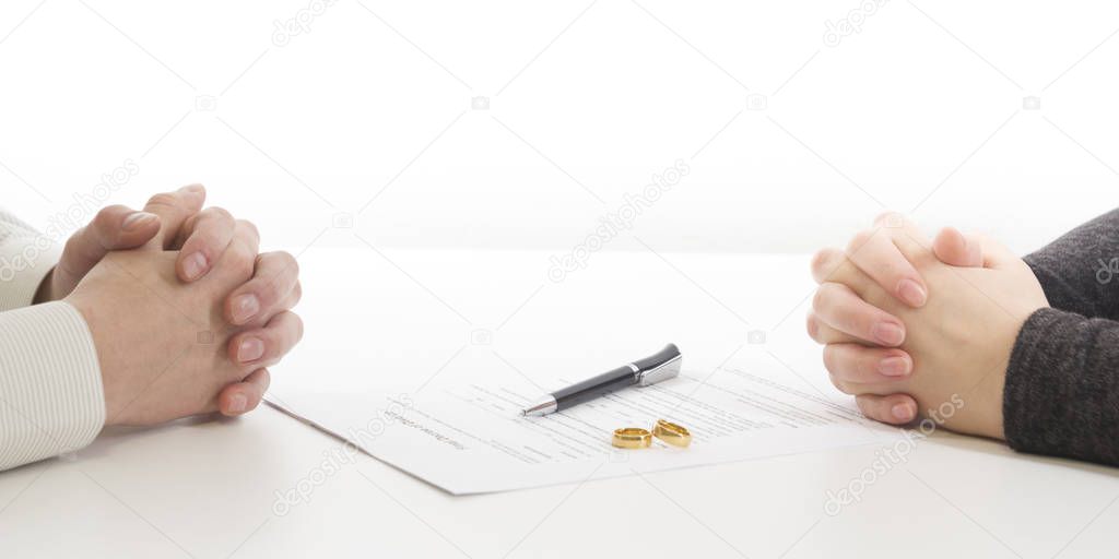 Divorce concept. Hands of wife, husband signing decree of divorce, canceling marriage, legal separation documents.