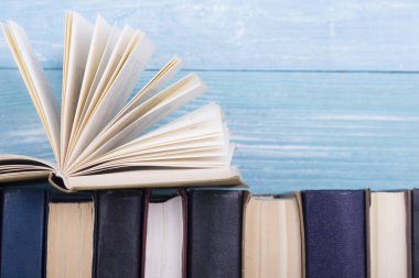 Açık kitap, ahşap masadaki ciltli kitaplar. Okula dönelim. Boşluğu kopyala