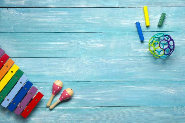 Marco colorido de los juguetes de los niños en fondo de madera. Vista superior. Acostado. Copiar espacio para texto . — Foto de Stock