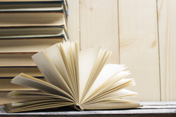 Open book, hardback books on wooden table. Back to school. Copy space