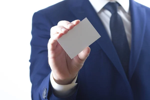 Hand holding white business card on white background — Stock Photo, Image