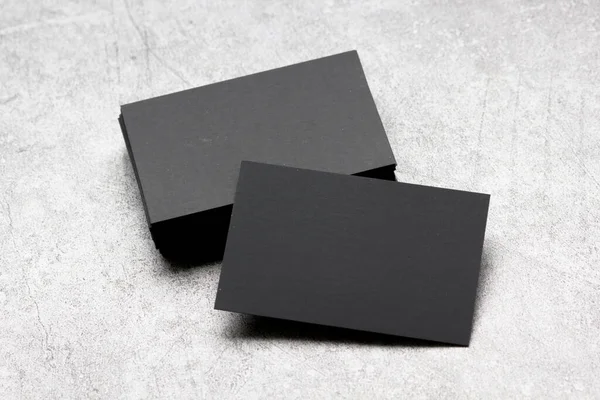 Black business cards blank on textured background. Identity design, corporate templates, company style. Flat lay