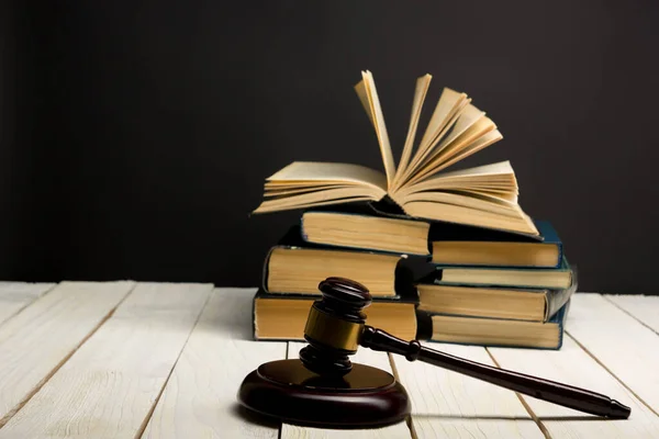 Концепція права - відкрита книга з дерев'яними суддями за столом у залі суду або правоохоронних органах, ізольованих на білому тлі. Копіювальний простір для тексту — стокове фото