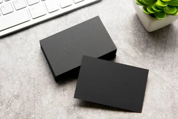 Black business cards blank on textured background. Identity design, corporate templates, company style. Flat lay