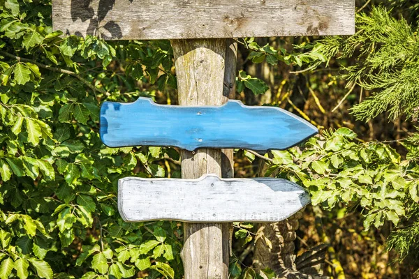 Wooden arrow sign with arrows in colors pointing in the right directions
