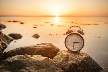 Çalar saat sabah okyanus tarafından Sunrise bir kayaya