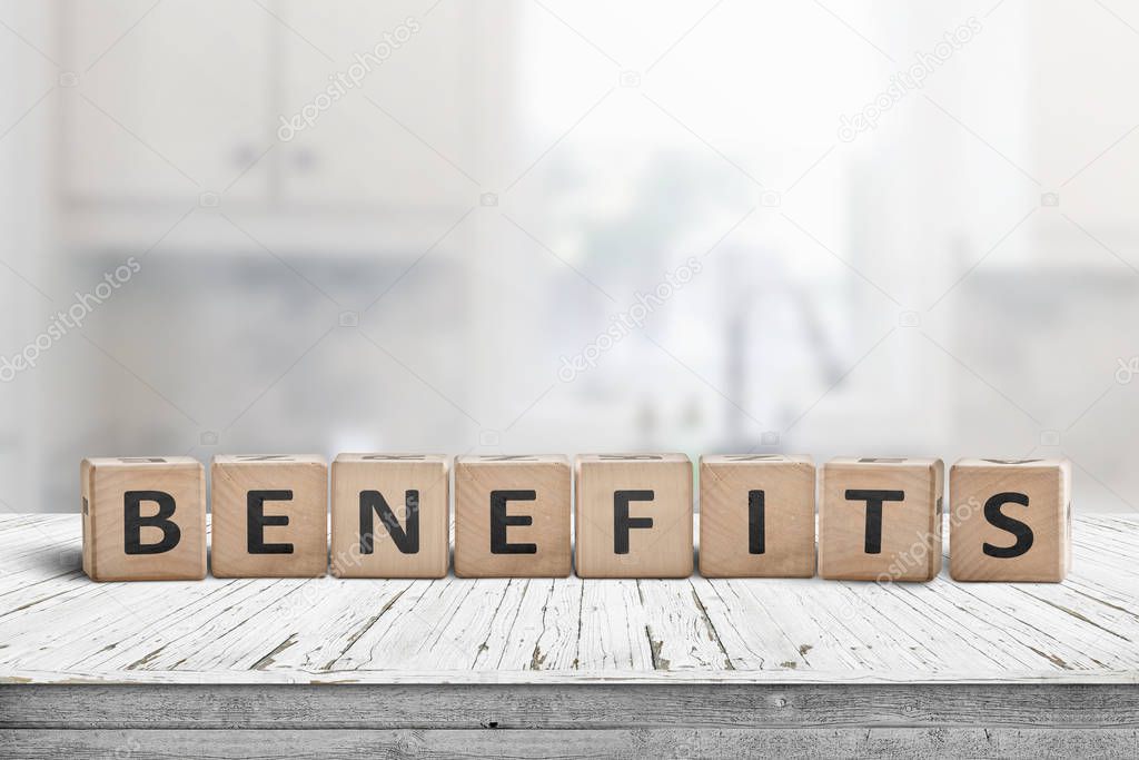 Benefits on a worn table in a bright room made with wooden blocks