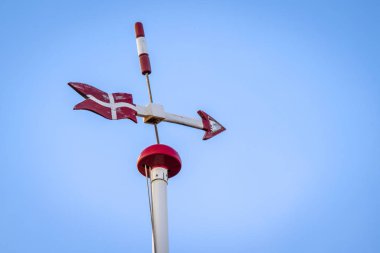 Danish weather vane with the flag of Denmark and an arrow sign pointing right clipart