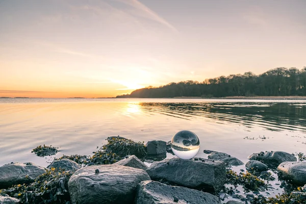 Orbe de vidro na rocha o junto ao lago — Fotografia de Stock