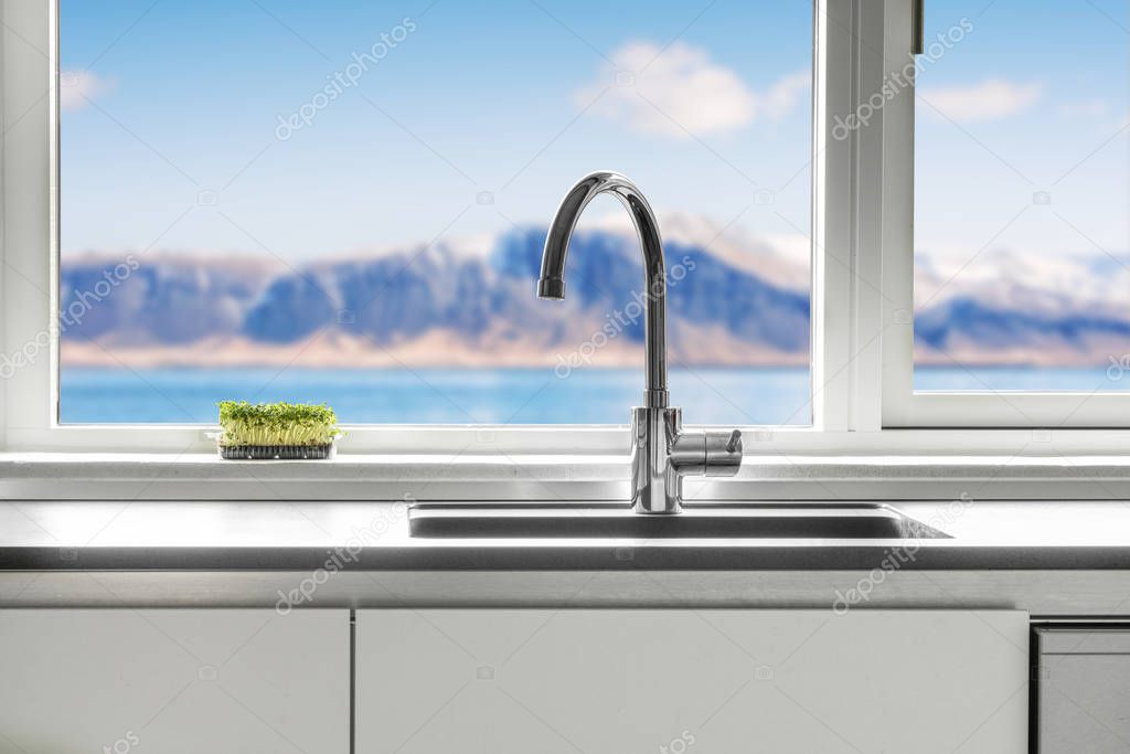 Kitchen sink by a window with a view