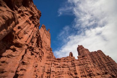 Looking up the red sandstone walls of the Fisher Towers in Utah. clipart