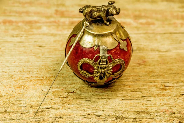 Acupuncture needle on antique Chinese paperweight — Stock Photo, Image