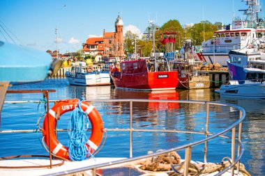 Fishing port of Ustka, Poland with old lighthouse clipart