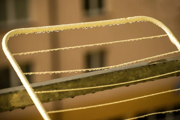 Drying rack on a balcony with raindrops — Stock Photo, Image