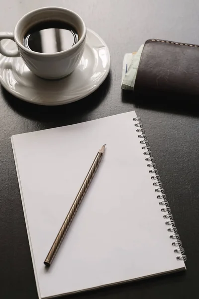 Schwarzer Schreibtisch Mit Kaffee Portemonnaie Papier Und Stift Nahaufnahme — Stockfoto