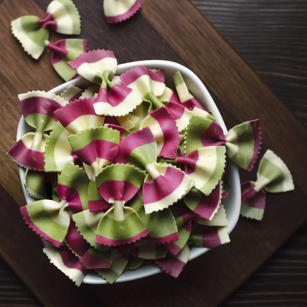 Italian raw multicolored farfalle pasta. View from above