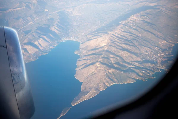 earth and plane wing view from window of airplane