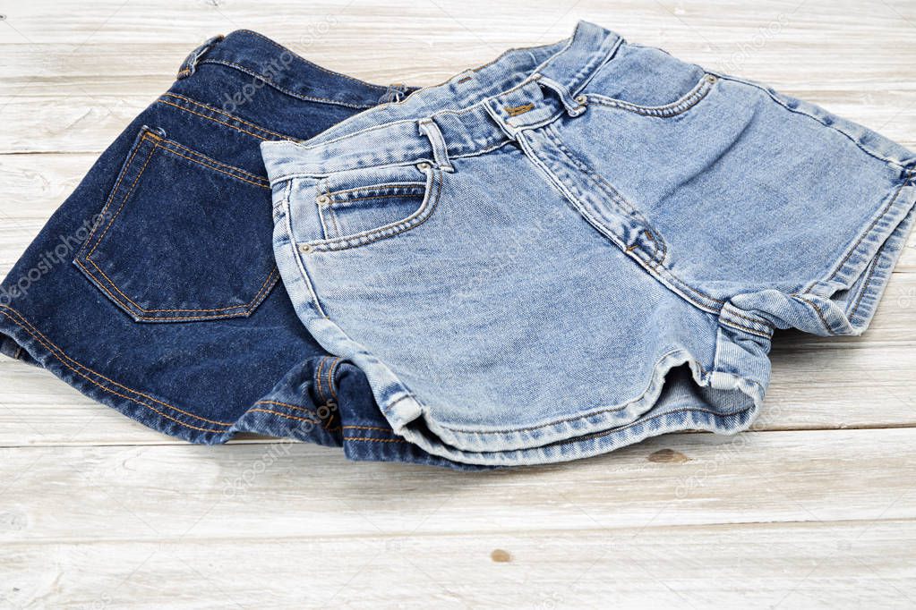 two vintage woman Jeans denim shorts on wooden shelf. shorts from new collection