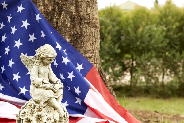 Winged girl angel with the flag of america decorating the garden in the house