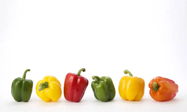 Colorful bell pepper vegetable isolated on white background ,minimal top view with copy space. Linear arrangement.