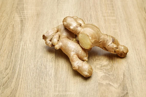Ham zencefil kökü rustik ahşap masa arka plan üzerine dilimlenmiş