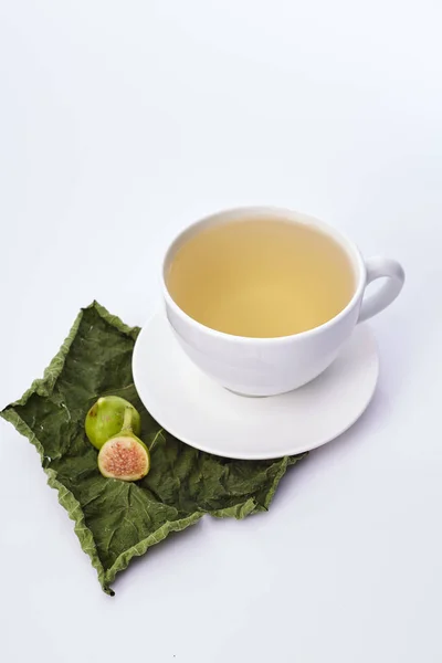 Cup Fig Leaf Tea on white background