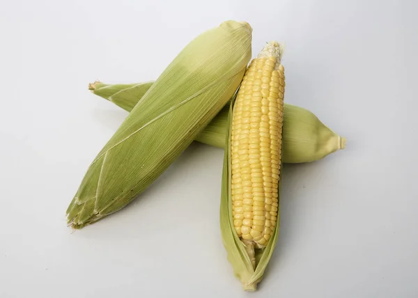 Fresh corn on white table background, closeup